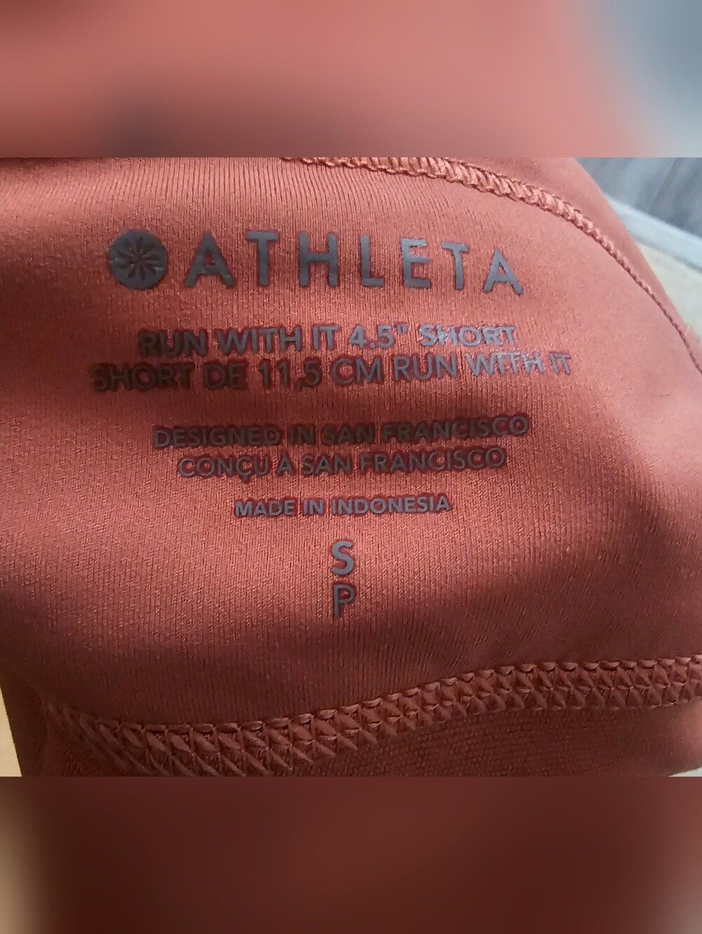 Athleta running shorts coral color feature a wide waistband and a side tag. Smal - Picture 5 of 8
